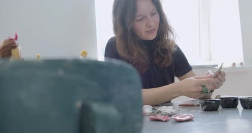 Woman crafting clay art in home studio