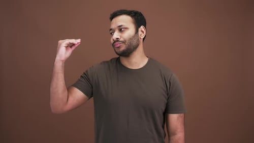 Studio Portrait of Boring Indian Man Making Blah Blah Gesture with His Hand Expressing Disbelief