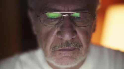 Senior Man Close Up with Eyeglasses at Night