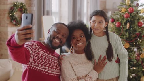 Happy Family Taking Christmas Selfies at Home