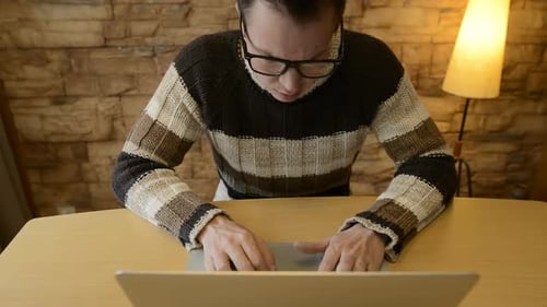 Stressed Young Man Looking Angry While Using Laptop at Home