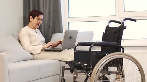 Handicapped Woman with Lapot Lay on Couch