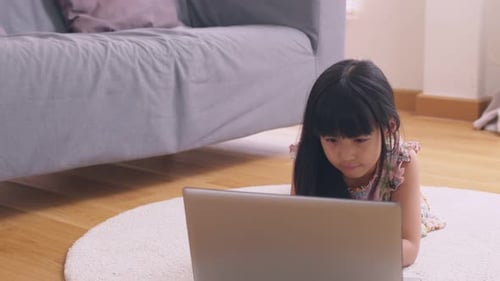 Girl Using Laptop Computer in Home