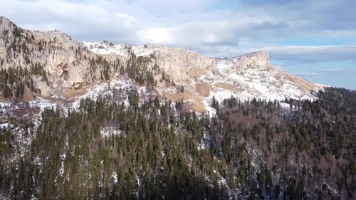 View of the beautiful snow-capped mountains on a winter day. Drone camera.