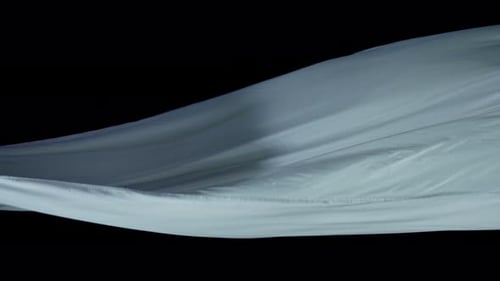 Rippling Light-Blue Fabric Abstract on Black