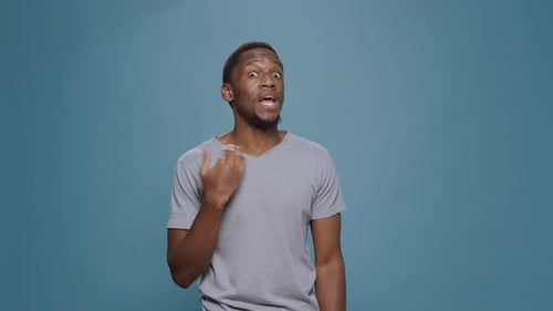 Young Adult gesturing, then touching neck and face