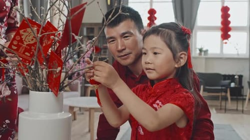 Father and Daughter Decorating for Lunar New Year