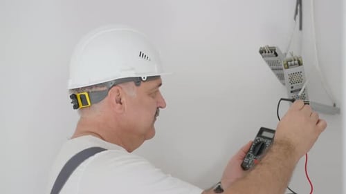Man Testing Electrical Circuits With Multimeter