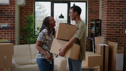 Happy Couple Moving into New Home with Boxes