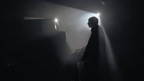 Musician Playing Piano in Dramatic Foggy Setting