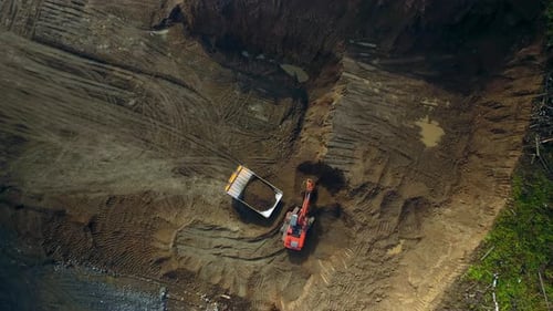 Aerial Top View Hyperlapse Excavator Loads Dump Truck with Earth
