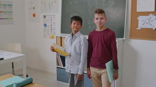 Teen Students Standing in Classroom with Folders
