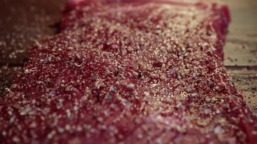 Seasoned Raw Steak with Ground Pepper Close Up