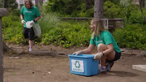Group of volunteers cleaning up park
