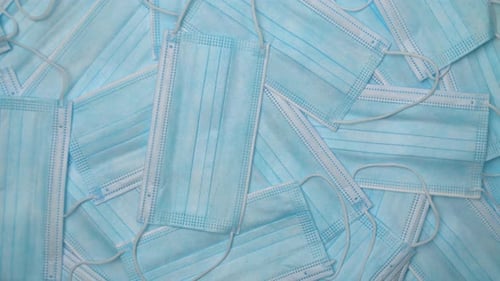 Pile of Light Blue Medical Face Masks