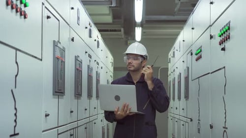 Engineer Communicating in an Industrial Control Room