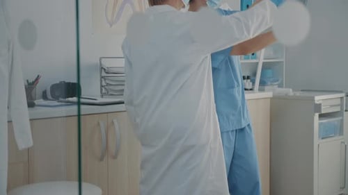 Medical Professionals Examining X-rays in Examination Room