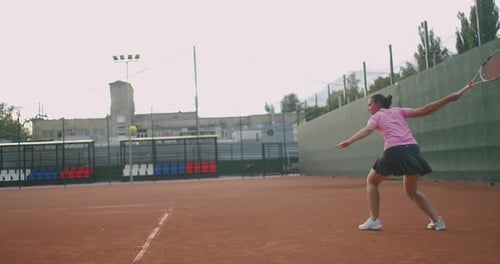 Female Tennis Player in Action During Game on the Professional Stadium. She Is Wearing Unbranded