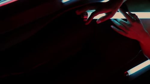 Sensual Woman Posing with Neon Lights in Dark Space