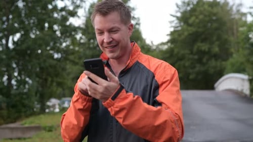 Young Handsome Man Using Phone And Thinking Outdoors