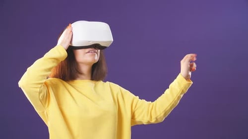 Woman Using Virtual Reality Headset Interacting with VR World