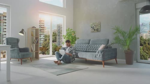 Man Using Tablet in Modern City Apartment