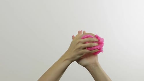 Woman Hands Playing Oddly Satisfying Pink Slime on White Backgroun, Antistress