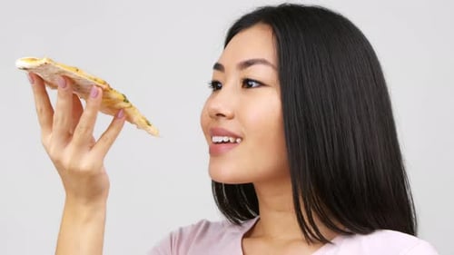 Woman Enjoying Slice of Pizza Close Up