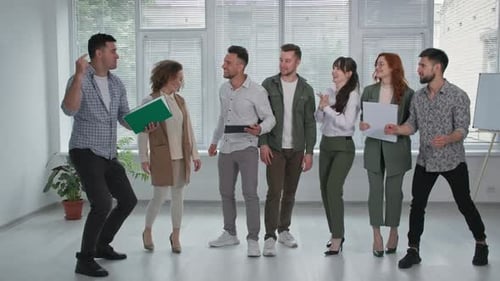 Excited Team Celebrates Success in Modern Office