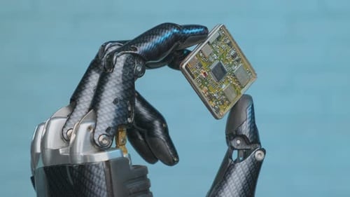 Robotic arm holds microchip close-up, new technologies