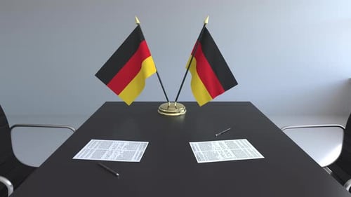 Business Negotiation with German Flags on Meeting Table