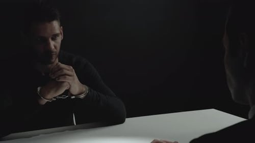 Man in Handcuffs During Interrogation at Night