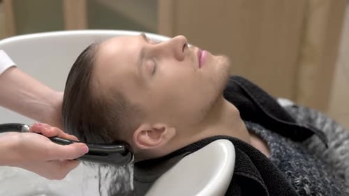 Man Getting Hair Washed at Salon
