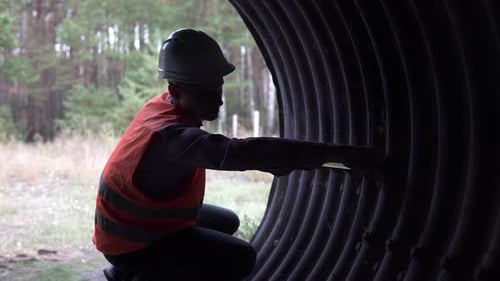 Ein Bauingenieur vermisst die Struktur einer Unterführung unter der Eisenbahn.