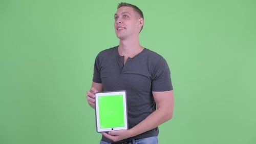 Young Adult Holding Tablet With Chroma Key Screen