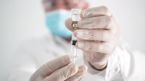 Medical Professional Preparing Injection in Hospital Setting