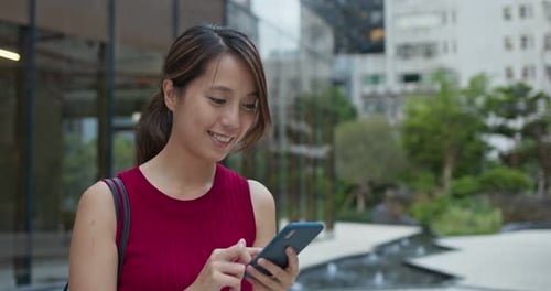 Woman use of mobile phone at street