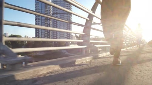 Athletic Women Jogging on City Bridge