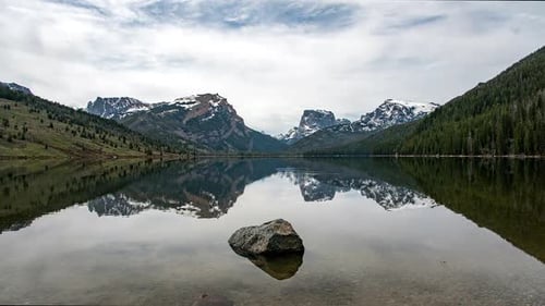 Time lapse of glassy lake viewing reflection of Square Top Mountain