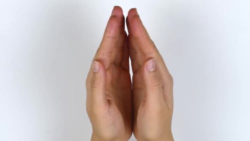 Woman's hands open. A view from above of the palms opening.