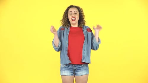 Woman with Curls Dancing on Yellow Background