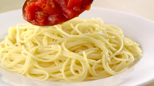 Adding Tomato Sauce to Spaghetti Noodles