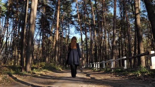 A woman walks in the woods