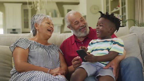 Grandparents and Child Laughing Together at Home