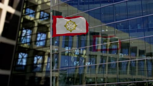 Buddhist Dharma Wheel Flag Waving in Front of Modern Building