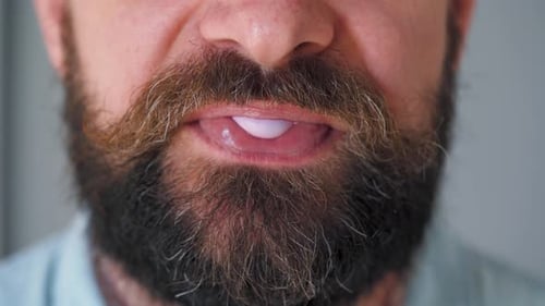 Bearded Man Chewing Bubble Gum. Man Blowing Out a Bubble of Chewing Gum