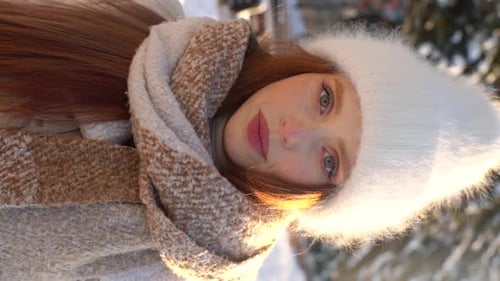 Vertical Portrait of Attractive Young Woman in Warm Winter Outerwear Standing Posing at City Park in