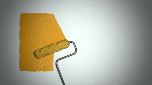 Roller paints the wall with yellow paint.