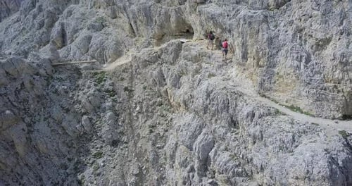Aerial drone view of a man and woman couple hiking in the mountains