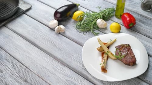 Steak and Vegetables Presented on White Plate